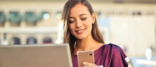 Women looking at her phone smiling