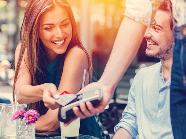 Women smiling and paying using her card