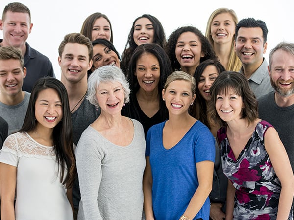 A big diverse group of people looking at the camera smiling
