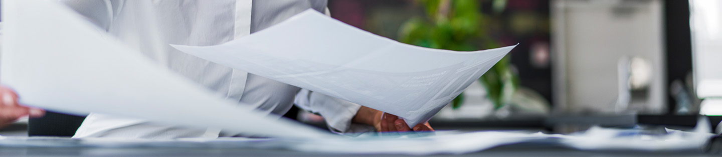 A gy looking at different sheets of paper